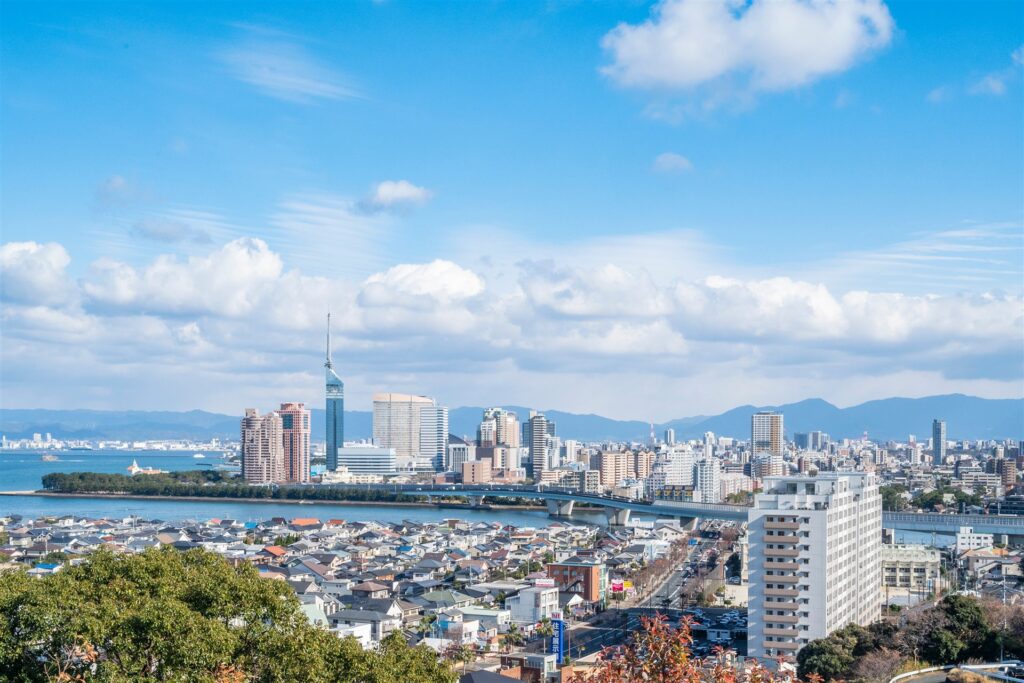 高台から見た海辺の福岡市の街並みと山並み