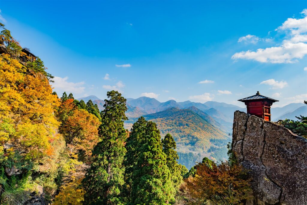 秋の山形県山形市の山寺と紅葉の山々