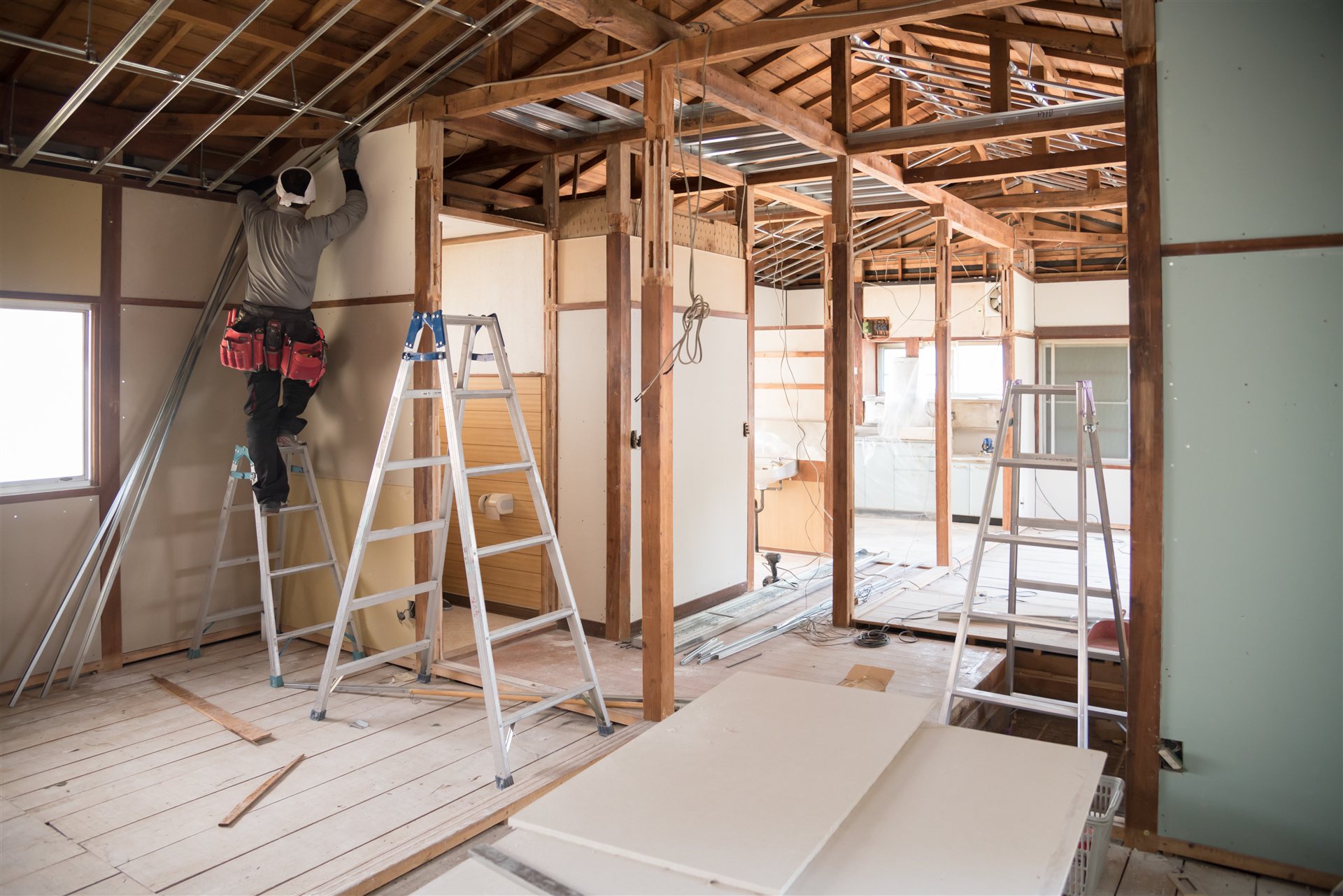 骨組みを見せた住宅のリフォーム工事の室内と脚立
