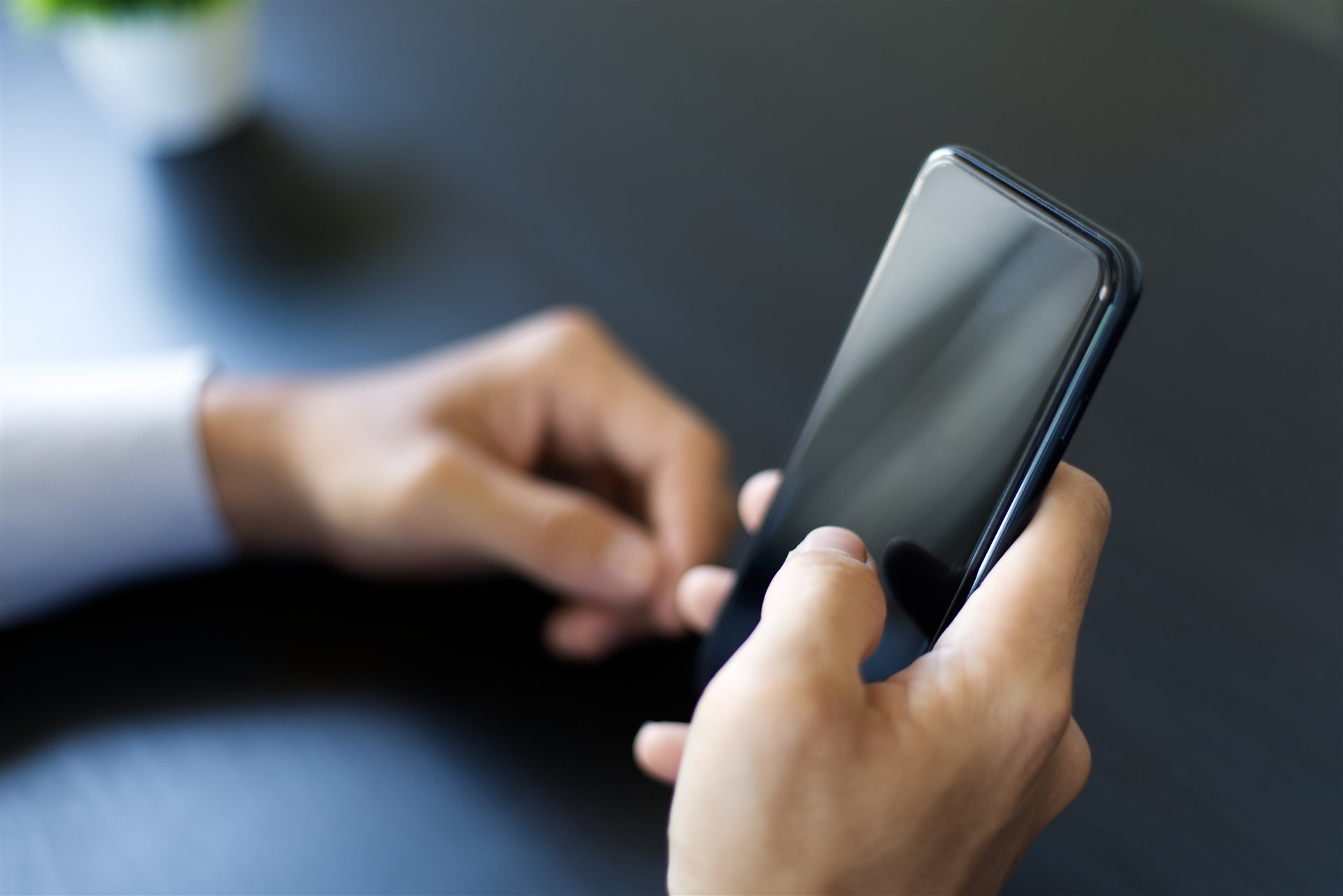 スマートフォンを操作する手元
